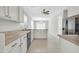 Well-lit kitchen featuring white cabinetry, a center island, and modern appliances at 12938 W Mandalay Ln, El Mirage, AZ 85335