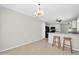 Open concept kitchen and dining area featuring tile floors, neutral walls, and modern lighting at 12938 W Mandalay Ln, El Mirage, AZ 85335