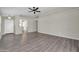 Spacious living room with wood floors, neutral walls, and a ceiling fan at 12938 W Mandalay Ln, El Mirage, AZ 85335