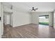 Bright living room with wood floors and a sliding glass door that provides access to the backyard at 12938 W Mandalay Ln, El Mirage, AZ 85335