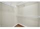 Empty walk-in closet with lots of shelving and wood floors at 12938 W Mandalay Ln, El Mirage, AZ 85335