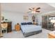 Cozy bedroom with ceiling fan, sliding glass door, and carpet floors at 13211 W Aleppo Dr, Sun City West, AZ 85375