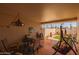 This covered patio has a hanging light fixture and a view of the back yard at 13211 W Aleppo Dr, Sun City West, AZ 85375