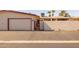 Street view of property featuring a garage, brick wall, and desert landscaping at 13211 W Aleppo Dr, Sun City West, AZ 85375