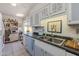 Bright kitchen featuring white cabinets, neutral countertops, and stainless steel sink at 13211 W Aleppo Dr, Sun City West, AZ 85375