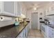 Functional kitchen with ceiling fan, white cabinets, and classic appliances at 13211 W Aleppo Dr, Sun City West, AZ 85375