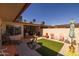 The fenced patio has an outdoor seating area, artificial turf, and desert landscaping at 13211 W Aleppo Dr, Sun City West, AZ 85375