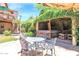 Serene backyard retreat with covered spa, lush greenery, and outdoor seating area, creating a private oasis at 1338 W Mountain View Dr, Mesa, AZ 85201