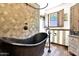 Rustic bathroom featuring a large copper tub, tile shower, and wood cabinets at 1338 W Mountain View Dr, Mesa, AZ 85201