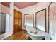 Luxurious bathroom with a clawfoot tub, glass enclosed shower, and custom wood cabinets with hardwood flooring at 1338 W Mountain View Dr, Mesa, AZ 85201