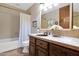 Neutral bathroom featuring wood cabinets, a large mirror, and shower-tub combo at 1338 W Mountain View Dr, Mesa, AZ 85201