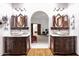 Spacious bathroom with double sinks, arched entrance and ornate cabinets at 1338 W Mountain View Dr, Mesa, AZ 85201