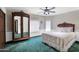 Cozy bedroom featuring plush green carpeting, an antique armoire, and white bedding at 1338 W Mountain View Dr, Mesa, AZ 85201