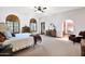 Spacious bedroom with large windows, carpeting and archway to sitting area at 1338 W Mountain View Dr, Mesa, AZ 85201