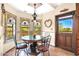 Breakfast nook with ornamental wrought iron windows with views of the backyard at 1338 W Mountain View Dr, Mesa, AZ 85201