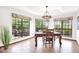 Bright dining room with backyard views, a decorative chandelier and glass table at 1338 W Mountain View Dr, Mesa, AZ 85201