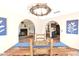 Dining room showing fireplace and kitchen views under decorative chandelier at 1338 W Mountain View Dr, Mesa, AZ 85201
