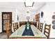 Dining room with an oversize glass table, hardwood floors, and room for eight chairs at 1338 W Mountain View Dr, Mesa, AZ 85201