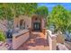 Stunning entryway with an iron gate, tiled pathway, and beautiful landscaping at 1338 W Mountain View Dr, Mesa, AZ 85201