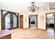Spacious foyer with hardwood floors, elegant lighting, and double door entry at 1338 W Mountain View Dr, Mesa, AZ 85201