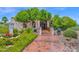 Inviting front entrance featuring lush landscaping and a decorative tile walkway leading to the home's entrance at 1338 W Mountain View Dr, Mesa, AZ 85201
