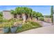 Charming exterior showcasing lush landscaping, decorative planters, and a welcoming walkway to the front door at 1338 W Mountain View Dr, Mesa, AZ 85201