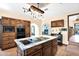 Spacious kitchen with wood cabinets, center island cooktop and a view of the breakfast nook at 1338 W Mountain View Dr, Mesa, AZ 85201