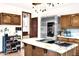 Stylish kitchen with a marble-topped island, stainless steel refrigerator, and decorative lighting at 1338 W Mountain View Dr, Mesa, AZ 85201