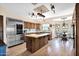Charming kitchen features wood cabinets, an island cooktop, stainless fridge and breakfast nook at 1338 W Mountain View Dr, Mesa, AZ 85201