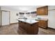 Bright laundry room with ample storage cabinets and a convenient center island countertop at 1338 W Mountain View Dr, Mesa, AZ 85201