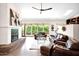 Bright living room with fireplace, plush leather seating, and large windows offering natural light and view at 1338 W Mountain View Dr, Mesa, AZ 85201