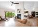 Spacious living room featuring a cozy fireplace, wood floors, and comfortable seating at 1338 W Mountain View Dr, Mesa, AZ 85201