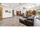 Spacious living room with wood floors, large sectional sofa, and view to the dining area at 1338 W Mountain View Dr, Mesa, AZ 85201