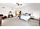 Large main bedroom with carpet, vanity, comfortable bed, and access to other areas of the home at 1338 W Mountain View Dr, Mesa, AZ 85201