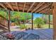 Covered patio showcasing outdoor lounge area with a view of the lush backyard at 1338 W Mountain View Dr, Mesa, AZ 85201