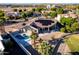 Aerial view of a beautiful backyard with a pool, patio, and solar panels on the tile roof at 14123 W Greentree S Dr, Litchfield Park, AZ 85340