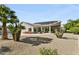 This beautiful backyard features a pool, solar panels, a covered patio, and lush landscaping at 14123 W Greentree S Dr, Litchfield Park, AZ 85340