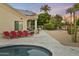 Stunning backyard oasis with a pool, patio furniture, and meticulously landscaped desert surroundings at 14123 W Greentree S Dr, Litchfield Park, AZ 85340