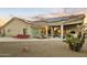 Gorgeous backyard with patio furniture, desert landscaping, solar panels on the roof, and covered patio at 14123 W Greentree S Dr, Litchfield Park, AZ 85340