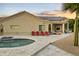 Beautiful backyard featuring a pool, patio with seating, and solar panels on the roof at 14123 W Greentree S Dr, Litchfield Park, AZ 85340