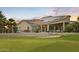 Home with solar panels and a fenced yard backing onto a golf course with lush green grass at 14123 W Greentree S Dr, Litchfield Park, AZ 85340
