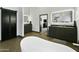 Contemporary bathroom featuring a large vanity with double sinks, a barn door and soaking tub at 14123 W Greentree S Dr, Litchfield Park, AZ 85340