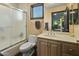 Well lit bathroom includes a bath and shower unit, single sink vanity and vanity mirror at 14123 W Greentree S Dr, Litchfield Park, AZ 85340