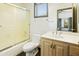 Bathroom with wood vanity, tiled floor, and shower with glass door at 14123 W Greentree S Dr, Litchfield Park, AZ 85340