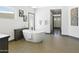 Bathroom with stand alone tub, tiled floors, and modern fixtures at 14123 W Greentree S Dr, Litchfield Park, AZ 85340