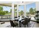 Elegant dining area with stylish table, chairs, and scenic backyard views at 14123 W Greentree S Dr, Litchfield Park, AZ 85340