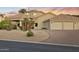 Single-story desert home with porte-cochere, three-car garage, and desert landscaping at 14123 W Greentree S Dr, Litchfield Park, AZ 85340