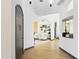 Bright foyer features light wood floors, white walls, and an arched entryway to the living room at 14123 W Greentree S Dr, Litchfield Park, AZ 85340