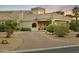 Charming home featuring lush landscaping, a curved driveway, and desert-friendly greenery at 14123 W Greentree S Dr, Litchfield Park, AZ 85340