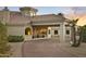 Beautiful desert home with porte-cochere, desert landscaping, brick driveway, and orange sky sunset at 14123 W Greentree S Dr, Litchfield Park, AZ 85340